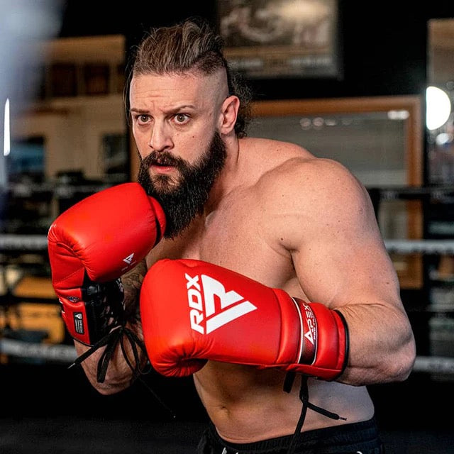 A Man shown wearingRDX APEX Training/Sparring Boxing Gloves Red