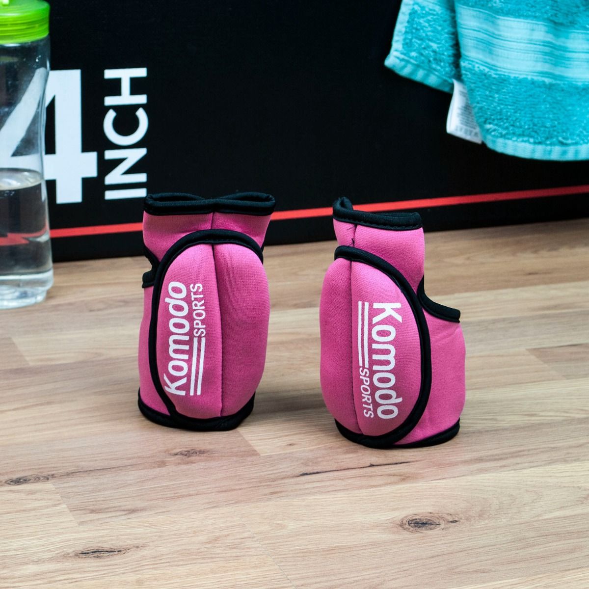 a pair of Komodo Sports Weighted Gloves in Pink